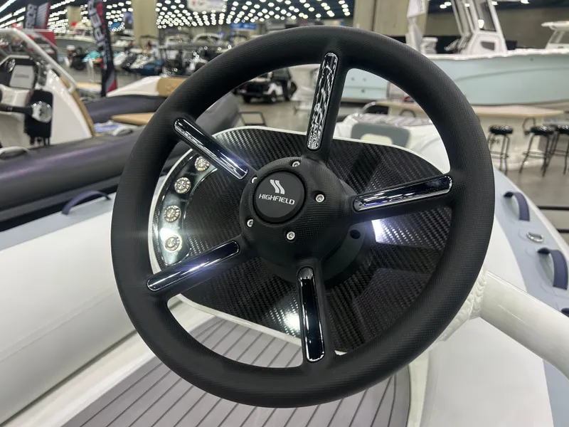 Slide: The Image of Steering wheel of 2025 Highfield Classic 400 boat, featuring sleek design and modern controls. - 5
