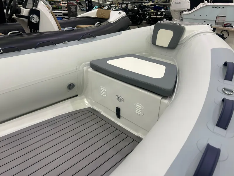 Slide: The Image of 2025 Highfield Classic 400 boat interior with cushioned seating and gray flooring. - 7