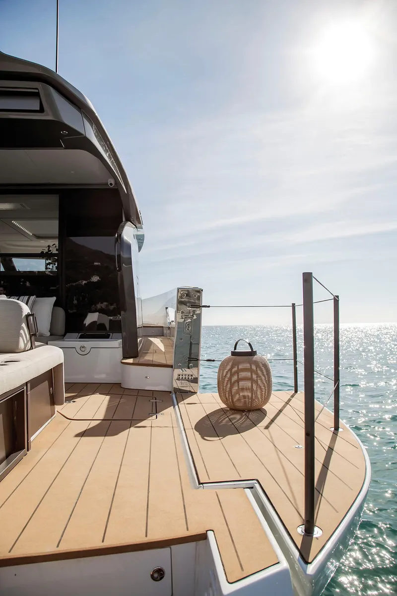 Slide: The Image of 2025 Azimut Seadeck 6 yacht deck with ocean view and sunlight. - 14