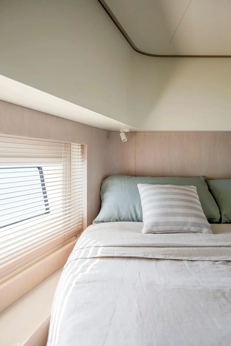 Slide: The Image of Interior cabin of 2025 Azimut Seadeck 6 yacht with cozy bed and window. - 26