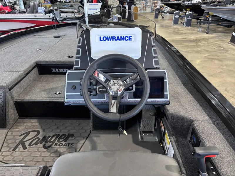 Slide: The Image of 2025 Ranger ALPHA 208 boat interior with steering wheel and Lowrance display. - 11