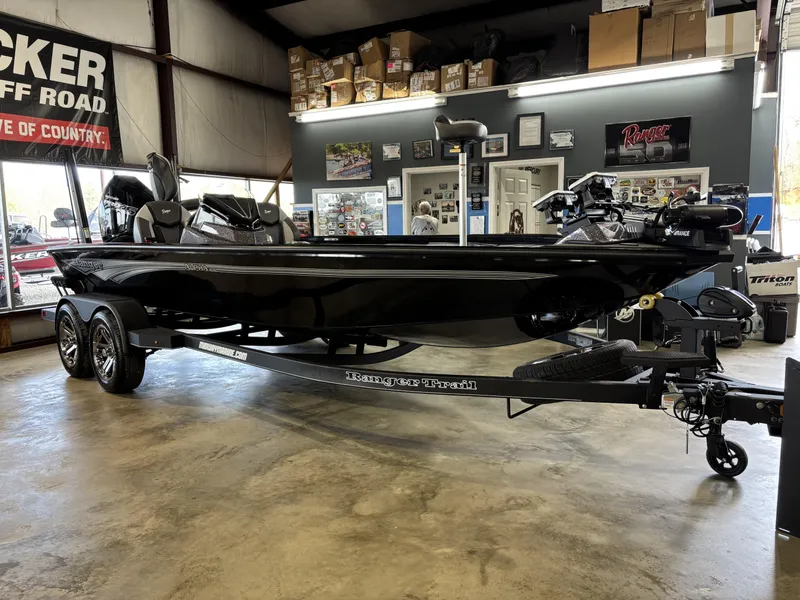 Slide: The Image of 2025 Ranger ALPHA 208 boat displayed indoors on a trailer. - 8