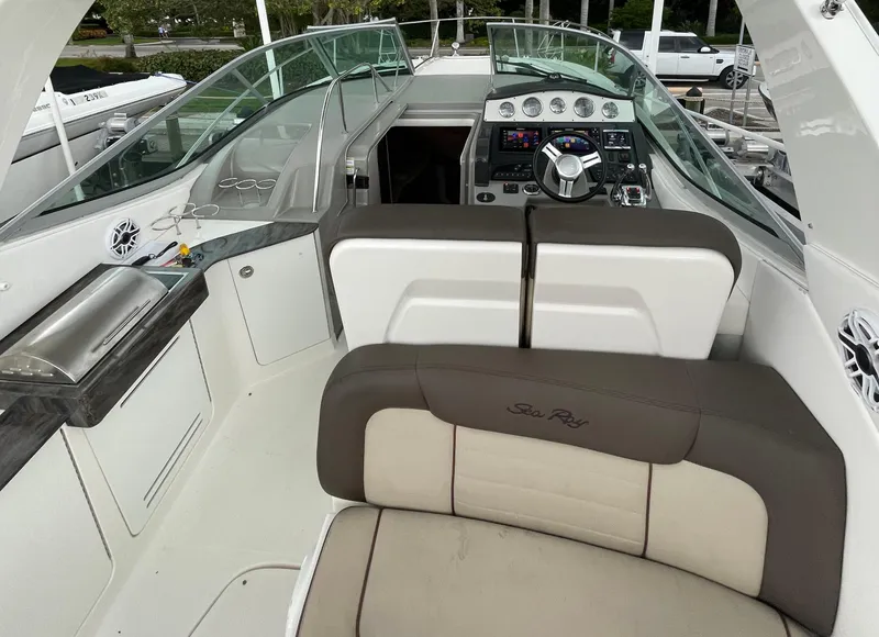 Slide: The Image of 2014 Sea Ray 330 Sundancer cockpit with helm, seating, and control panel. - 1