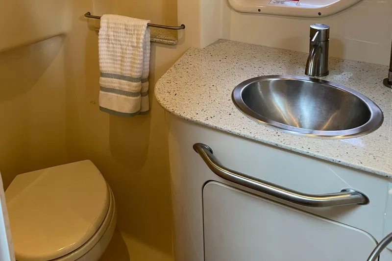 Slide: The Image of 2014 Sea Ray 330 Sundancer bathroom with sink and toilet. - 17