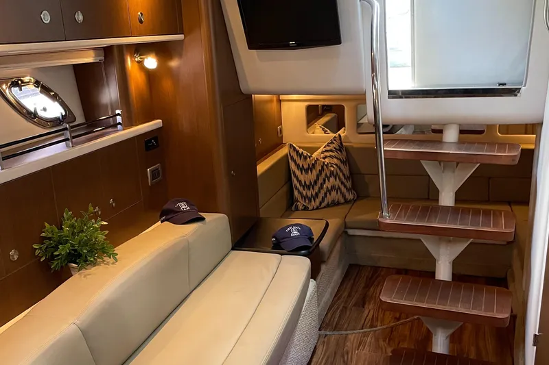 Slide: The Image of Interior of 2014 Sea Ray 330 Sundancer yacht with cozy seating and modern decor. - 19