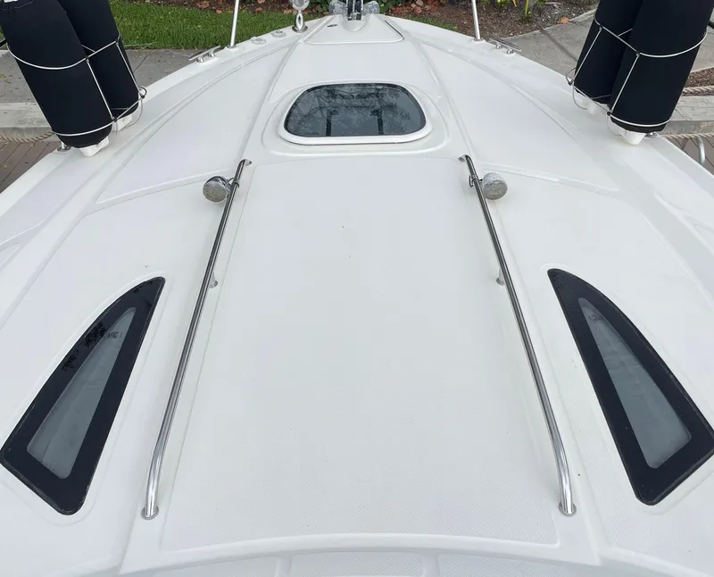 Slide: The Image of 2014 Sea Ray 330 Sundancer boat deck with sleek design and stainless steel railings. - 25