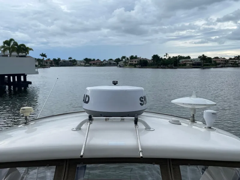 Slide: The Image of Bow view of 2014 Sea Ray 330 Sundancer on a calm waterway under cloudy skies. - 26