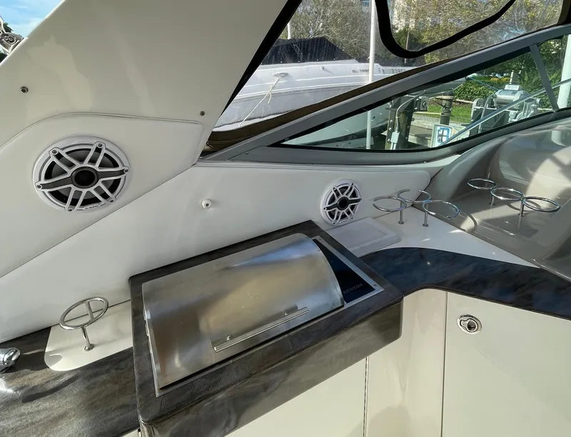 Slide: The Image of 2014 Sea Ray 330 Sundancer boat interior with speakers and stainless steel grill. - 4