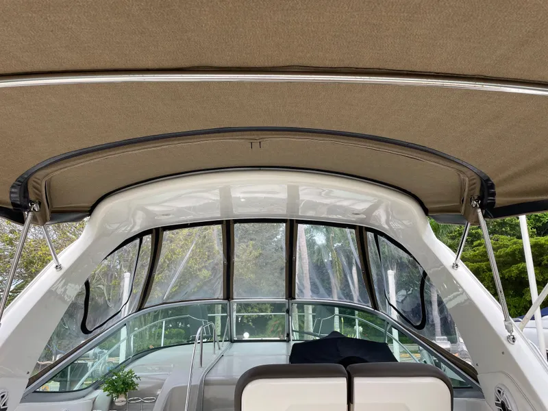 Slide: The Image of 2014 Sea Ray 330 Sundancer cockpit with canopy and seating area. - 5