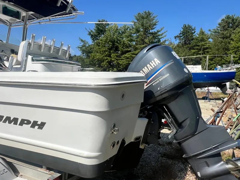 Slide: The Image of 2005 Triumph 23 Center Console boat with Yamaha outboard motor, parked outdoors. - 4