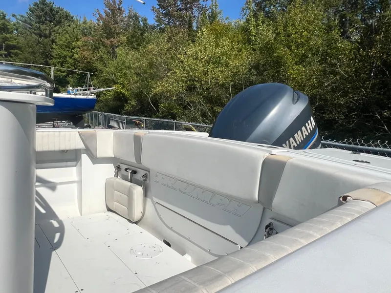 Slide: The Image of 2005 Triumph 23 Center Console boat with Yamaha engine, outdoor setting. - 6