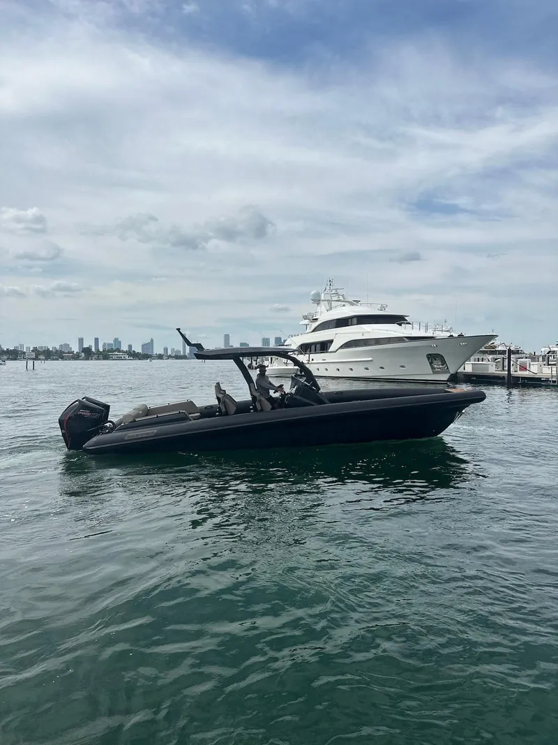 Slide: The Image of 2025 Skipper-BSK 34 boat on water with city skyline in background. - 14
