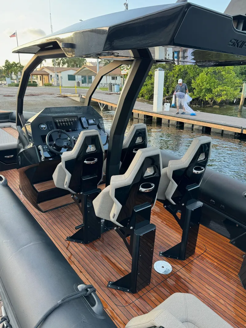 Slide: The Image of 2025 Skipper-BSK 34 boat interior with modern seating and wooden deck. - 18