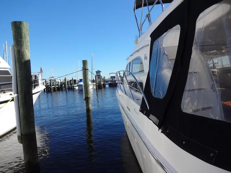 Slide: The Image of 1999 Sealine F44 yacht docked at a marina under clear blue skies. - 10