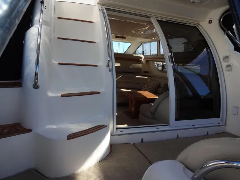 Slide: The Image of Interior view of 1999 Sealine F44 yacht, featuring elegant seating and wooden accents. - 12