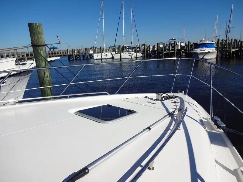 Slide: The Image of Sealine F44 yacht from 1999 docked at a marina with clear blue skies. - 14