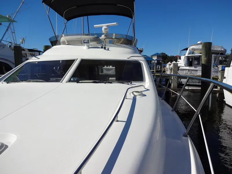Slide: The Image of 1999 Sealine F44 yacht docked at marina under clear blue sky. - 16