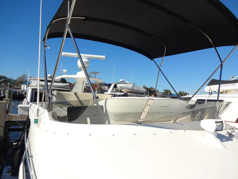 Slide: The Image of 1999 Sealine F44 yacht with canopy, docked under clear blue sky. - 19