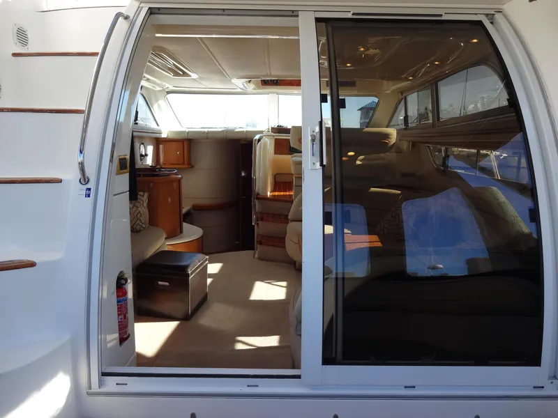 Slide: The Image of Interior view of a 1999 Sealine F44 yacht, featuring luxurious seating and elegant design. - 21