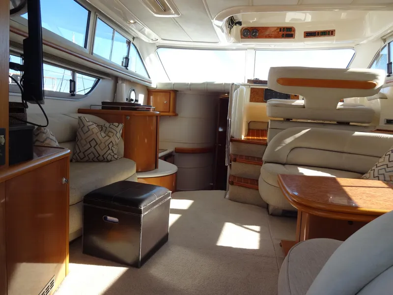 Slide: The Image of Luxurious interior of a 1999 Sealine F44 yacht with elegant seating and wooden accents. - 23