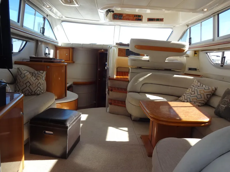 Slide: The Image of Luxurious interior of a 1999 Sealine F44 yacht, featuring elegant seating and wooden accents. - 24