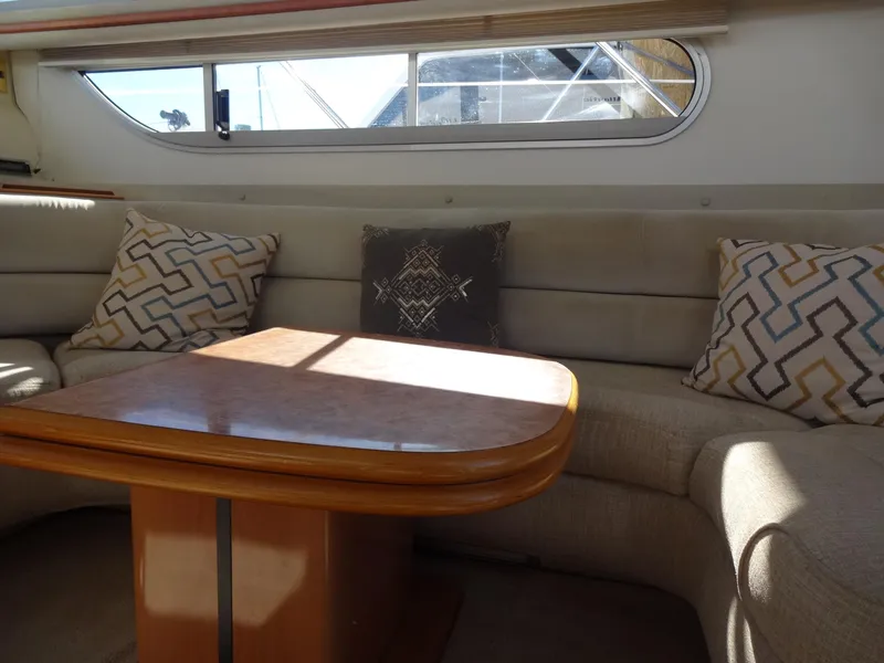 Slide: The Image of Interior of 1999 Sealine F44 yacht with cushioned seating and decorative pillows. - 26
