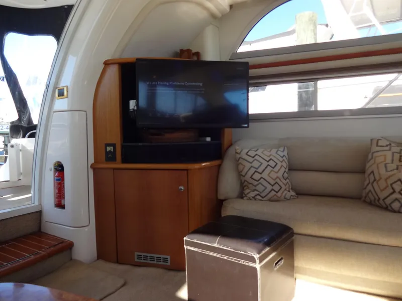 Slide: The Image of Interior of 1999 Sealine F44 yacht with sofa, TV, and wooden cabinetry. - 28