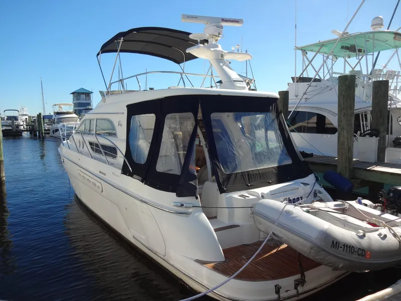 Slide: The Image of 1999 Sealine F44 yacht docked at marina with inflatable boat attached. - 3