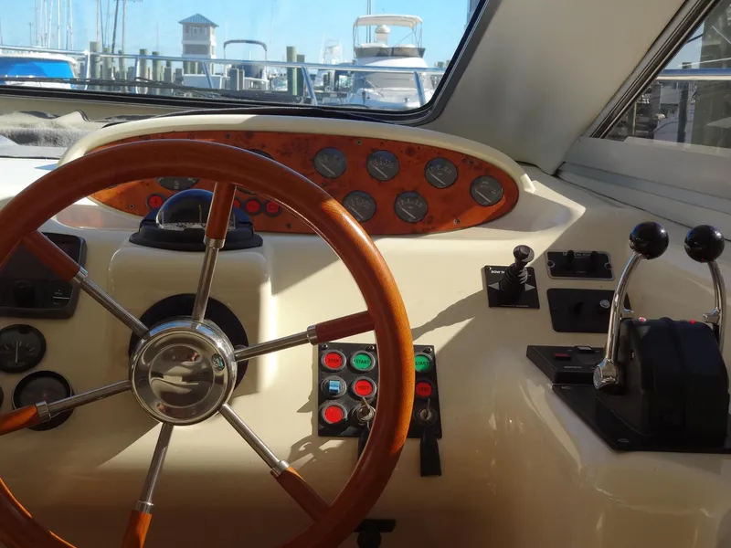Slide: The Image of 1999 Sealine F44 yacht helm with wooden steering wheel and control panel. - 34