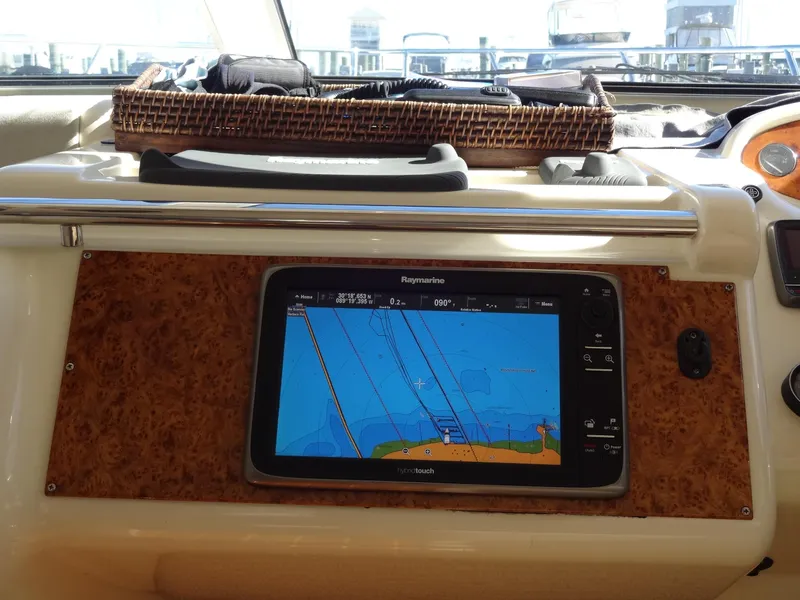 Slide: The Image of Navigation system on 1999 Sealine F44 yacht dashboard, featuring Raymarine display. - 35