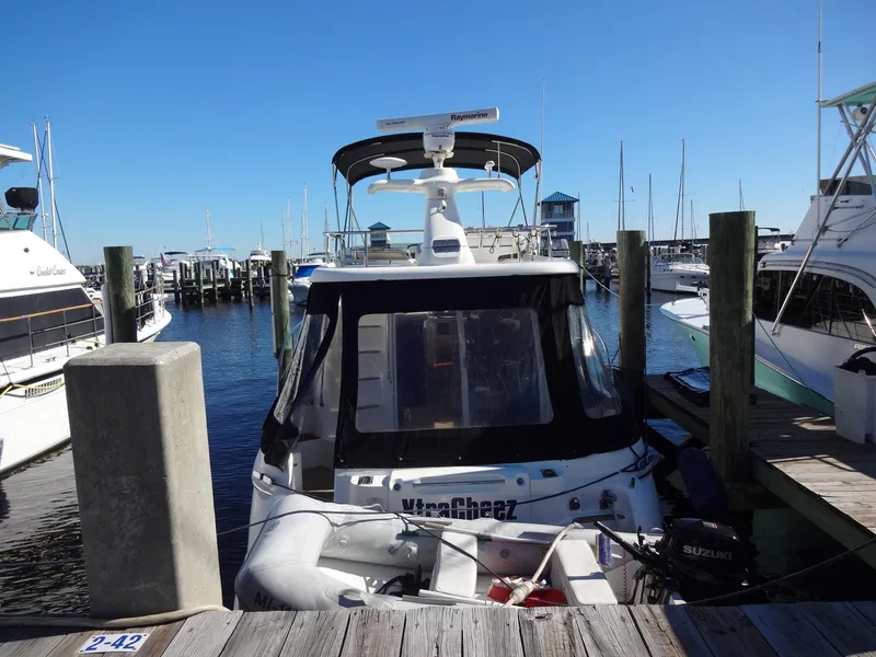 Slide: The Image of 1999 Sealine F44 yacht docked at a marina, surrounded by other boats. - 4