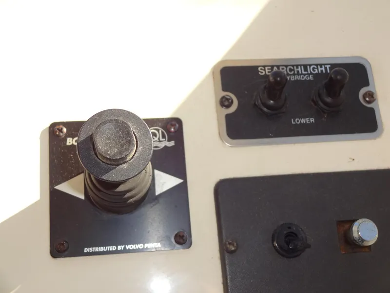Slide: The Image of Control panel of a 1999 Sealine F44 boat with searchlight switches. - 40