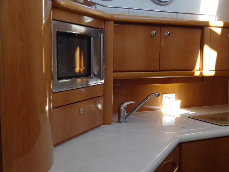 Slide: The Image of Interior of 1999 Sealine F44 yacht kitchen with wooden cabinets and modern appliances. - 41