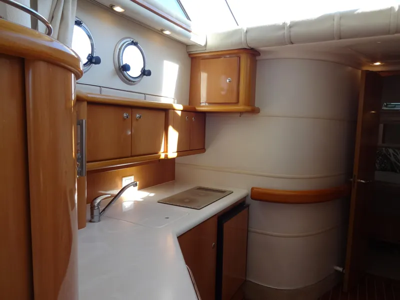 Slide: The Image of Interior of 1999 Sealine F44 yacht kitchen with wooden cabinets and porthole windows. - 43