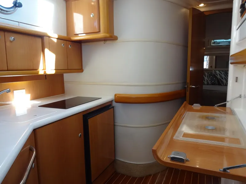 Slide: The Image of Interior of 1999 Sealine F44 yacht kitchen with wooden cabinets and modern appliances. - 44