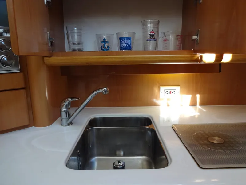 Slide: The Image of Kitchen area of a 1999 Sealine F44 yacht with sink and countertop. - 46