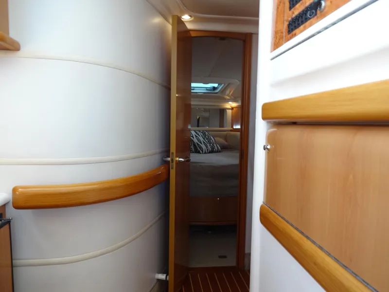 Slide: The Image of Interior of 1999 Sealine F44 yacht, featuring a cozy bedroom with wooden accents. - 47