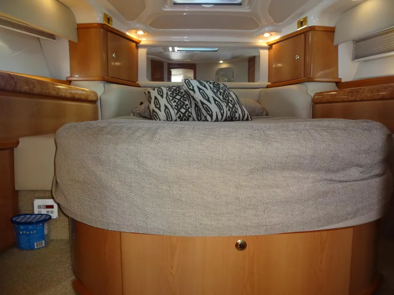 Slide: The Image of Interior of 1999 Sealine F44 yacht with cozy bed and wooden cabinetry. - 49