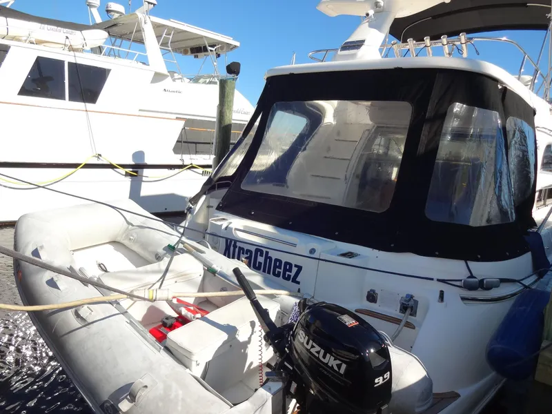 Slide: The Image of 1999 Sealine F44 yacht with inflatable boat and Suzuki outboard motor at dock. - 5