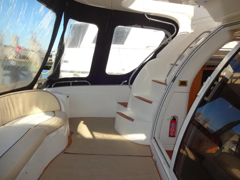 Slide: The Image of Interior of 1999 Sealine F44 yacht with seating and stairs, featuring large windows. - 6