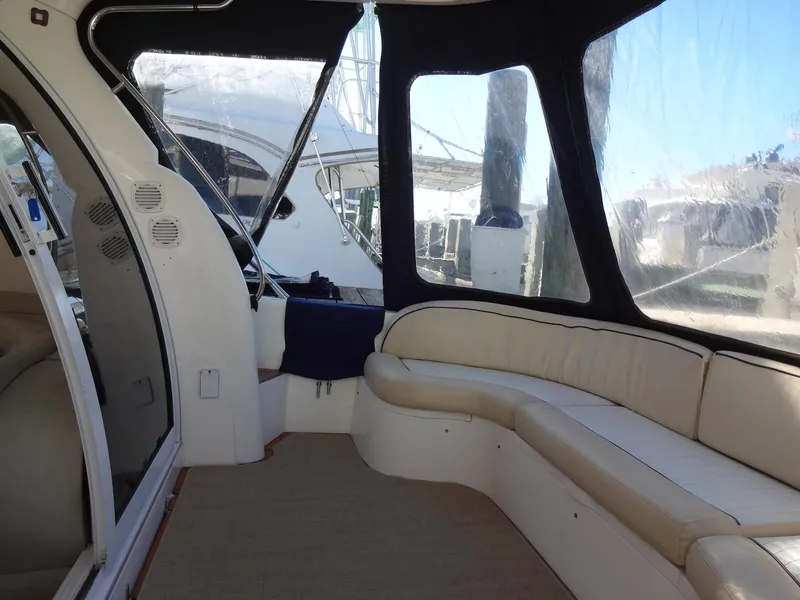 Slide: The Image of Interior of 1999 Sealine F44 yacht with cream seating and clear windows. - 9