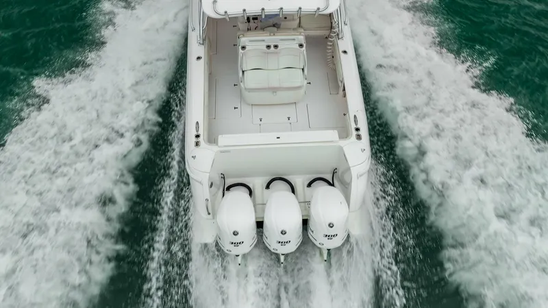 Slide: The Image of 2016 Intrepid 400 Cuddy boat with triple engines cruising on water, aerial view. - 10