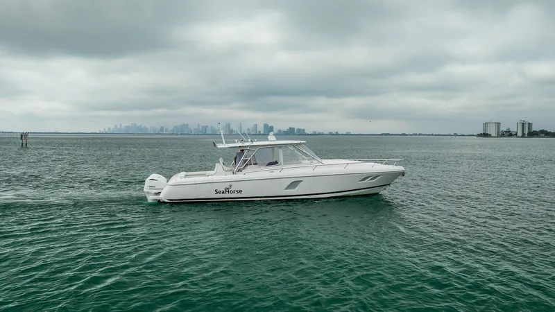 Slide: The Image of 2016 Intrepid 400 Cuddy cruising on open water under cloudy skies. - 11