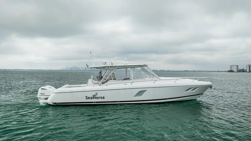 Slide: The Image of 2016 Intrepid 400 Cuddy boat named SeaHorse on open water. - 12