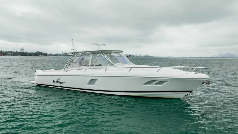 Slide: The Image of 2016 Intrepid 400 Cuddy boat on calm water under cloudy skies. - 13