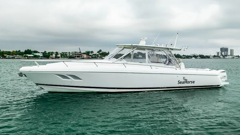 Slide: The Image of 2016 Intrepid 400 Cuddy boat named SeaHorse on calm water. - 16