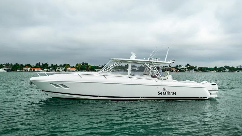 Slide: The Image of 2016 Intrepid 400 Cuddy boat on water, side view, overcast sky. - 17
