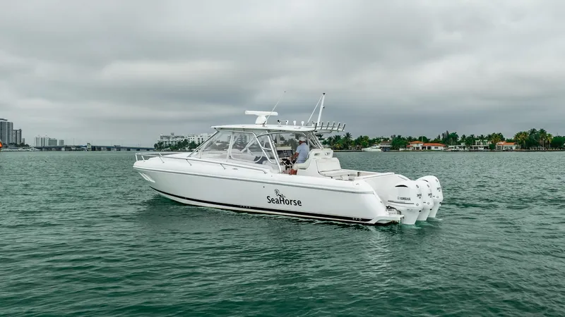 Slide: The Image of 2016 Intrepid 400 Cuddy boat on water, overcast sky, labeled "SeaHorse." - 18