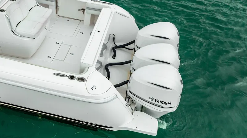 Slide: The Image of 2016 Intrepid 400 Cuddy with triple Yamaha outboard engines on turquoise water. - 19