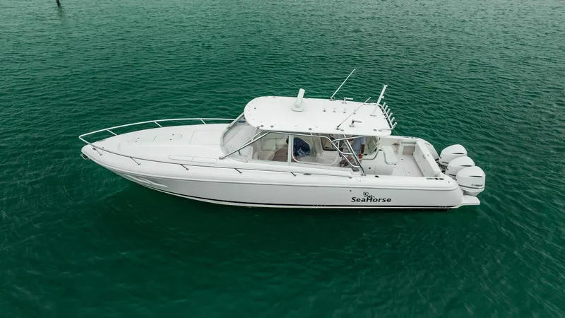 Slide: The Image of 2016 Intrepid 400 Cuddy boat on calm green water. - 23